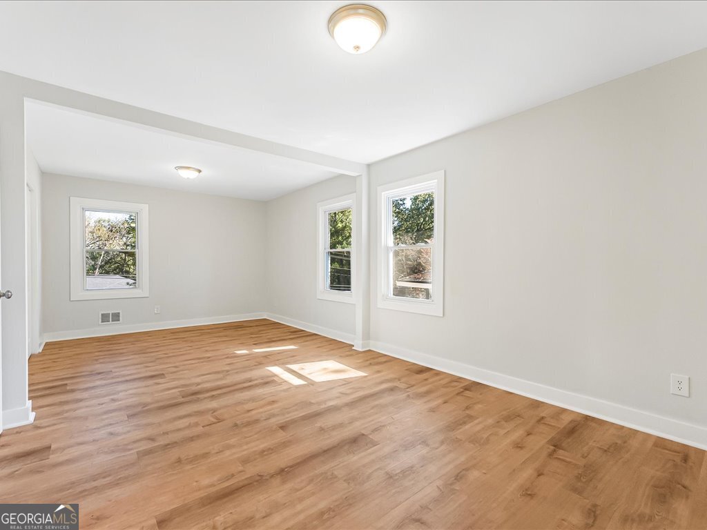 2905 Gresham Rd S East Atlanta, GA 30316 - Photo 20 of 27 a view of empty room with wooden floor and fan