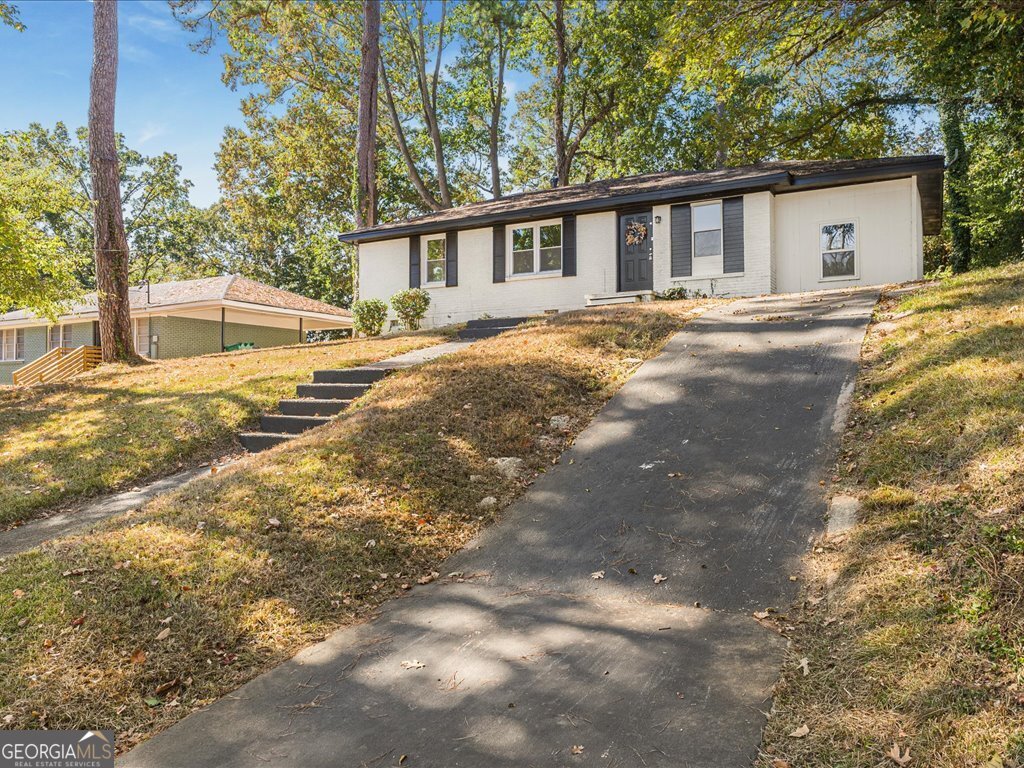2905 Gresham Rd S East Atlanta, GA 30316 - Photo 3 of 27 a front view of a house with a yard and trees