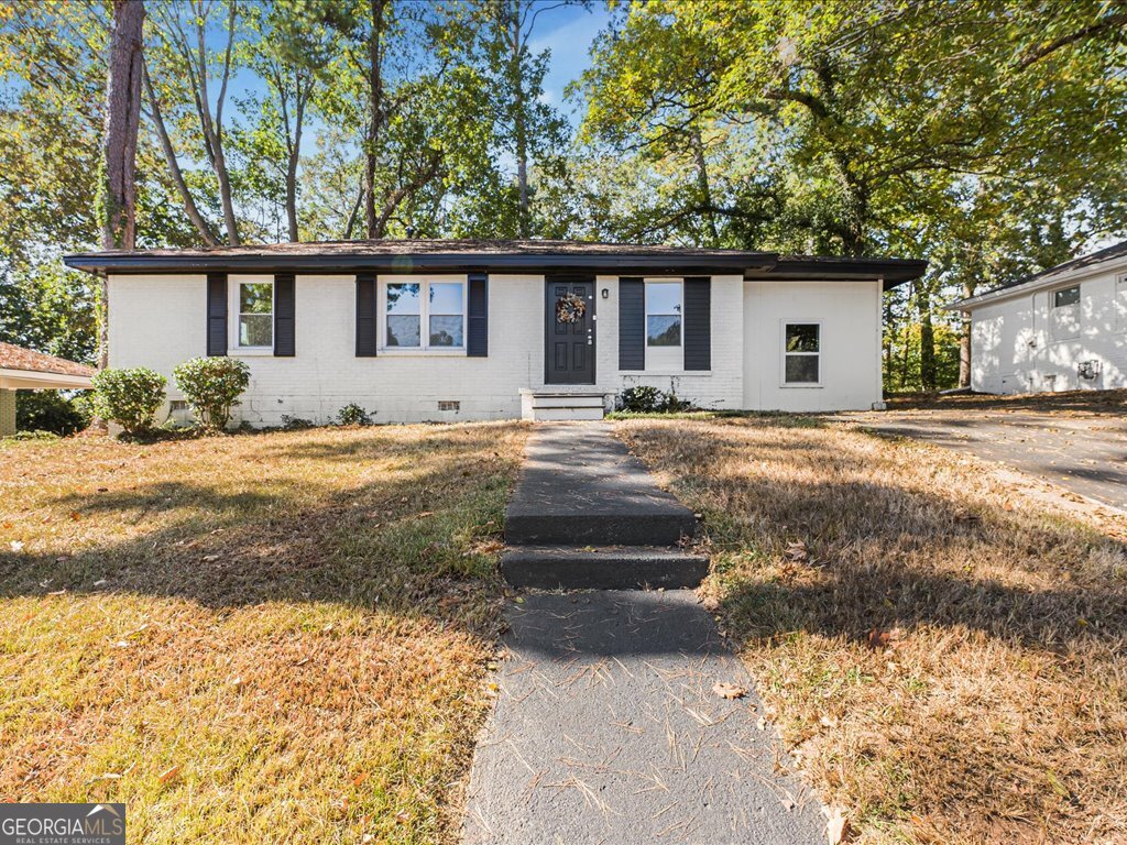 2905 Gresham Rd S East Atlanta, GA 30316 - Photo 4 of 27 a front view of a house with a yard and garage
