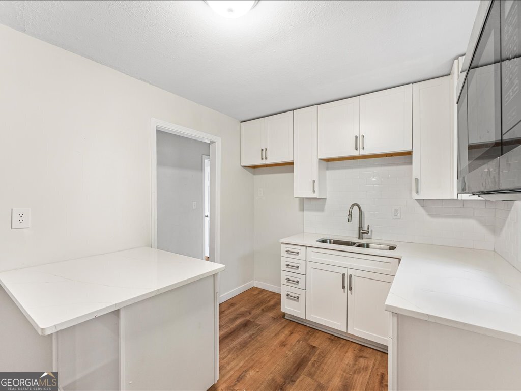 2905 Gresham Rd S East Atlanta, GA 30316 - Photo 8 of 27 a kitchen with stainless steel appliances a sink stove and white cabinets