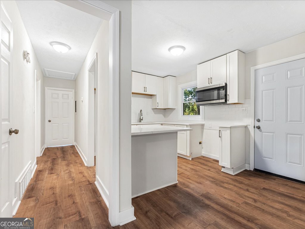 2905 Gresham Rd S East Atlanta, GA 30316 - Photo 9 of 27 a kitchen with white cabinets and appliances