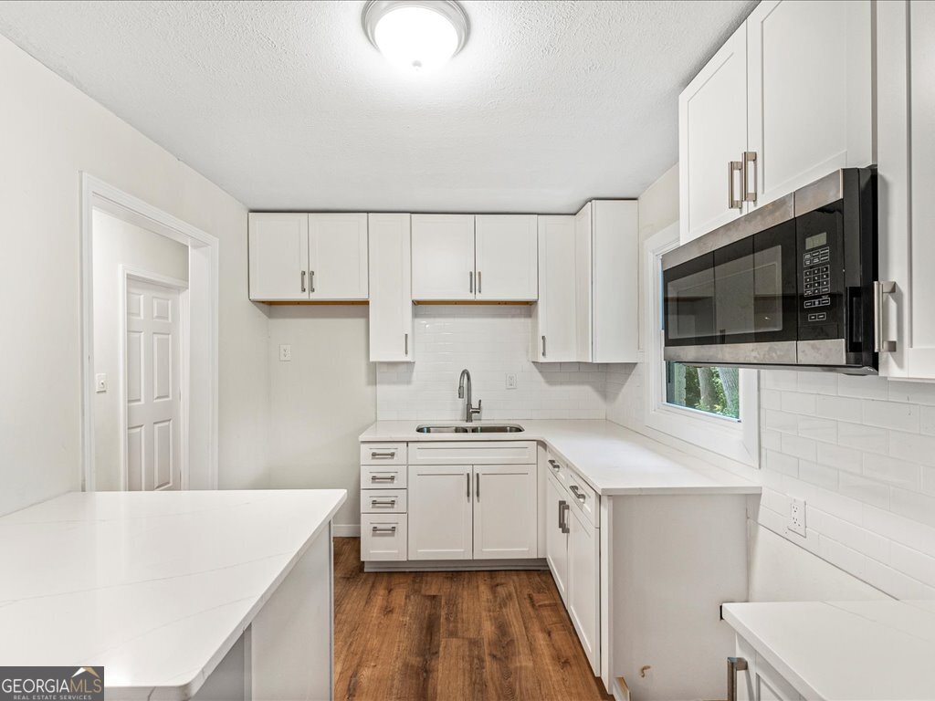 2905 Gresham Rd S East Atlanta, GA 30316 - Photo 10 of 27 a kitchen with stainless steel appliances a stove microwave sink and cabinets