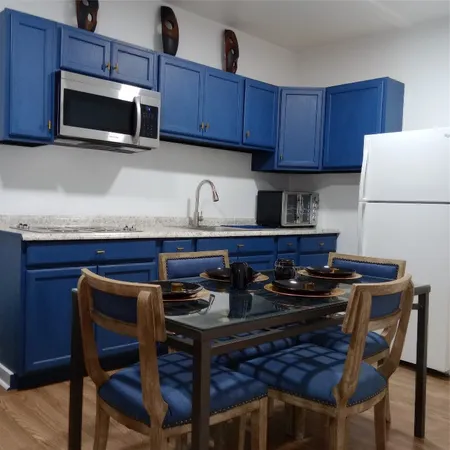 a kitchen with a stove a microwave and wooden cabinets