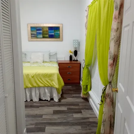 a bed room with a bed and painting on the wall