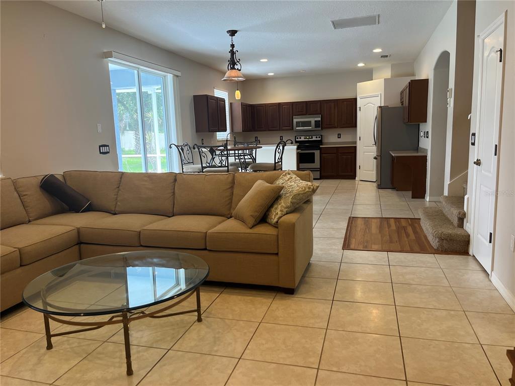 5966 Willows Bridge Loop Ellenton, FL 34222 - Photo 16 of 57 a living room with furniture kitchen view and a large window