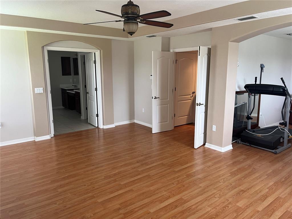 5966 Willows Bridge Loop Ellenton, FL 34222 - Photo 31 of 57 a view of a livingroom with wooden floor and a ceiling fan