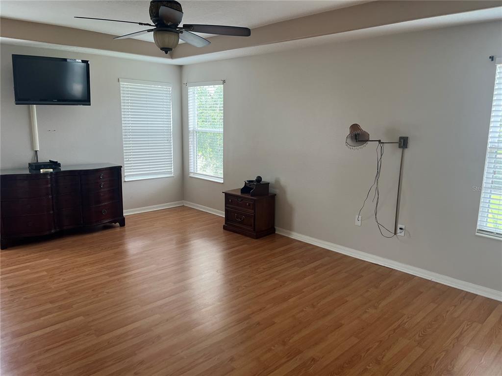 5966 Willows Bridge Loop Ellenton, FL 34222 - Photo 32 of 57 a living room with hard wood floors and a ceiling fan