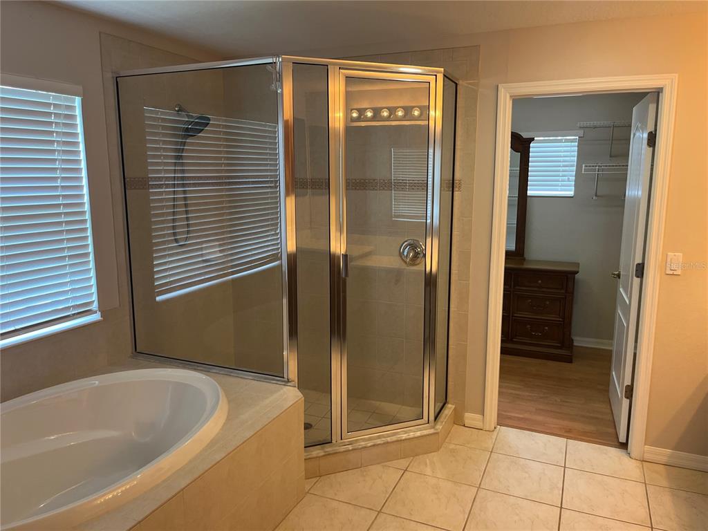 5966 Willows Bridge Loop Ellenton, FL 34222 - Photo 35 of 57 a bathroom with a bathtub and a shower