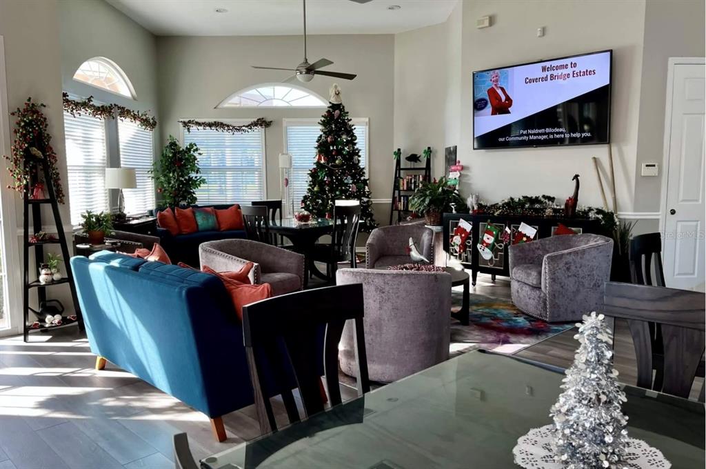 5966 Willows Bridge Loop Ellenton, FL 34222 - Photo 51 of 57 a living room with fireplace furniture and a chandelier