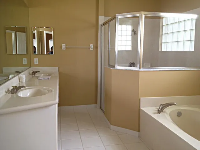 a bathroom with a tub sink and mirror