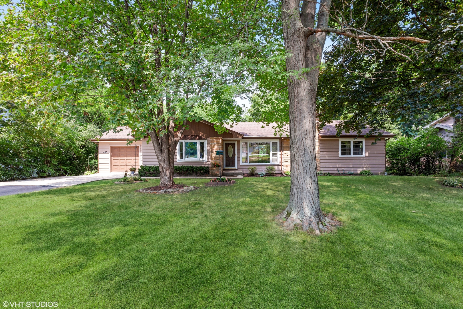 a front view of a house with a garden