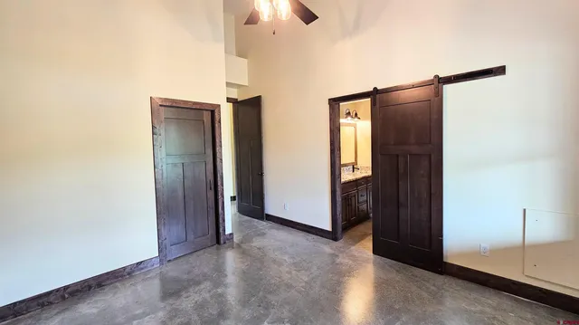 a view of a hallway to rooms