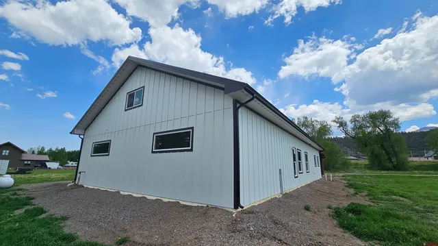a view of backyard of house and garage