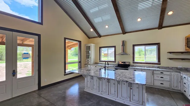 a kitchen with stainless steel appliances granite countertop a stove a sink and a refrigerator