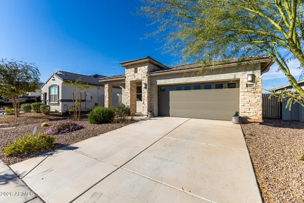 a front view of a house with a garden