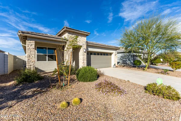 a front view of a house with garden