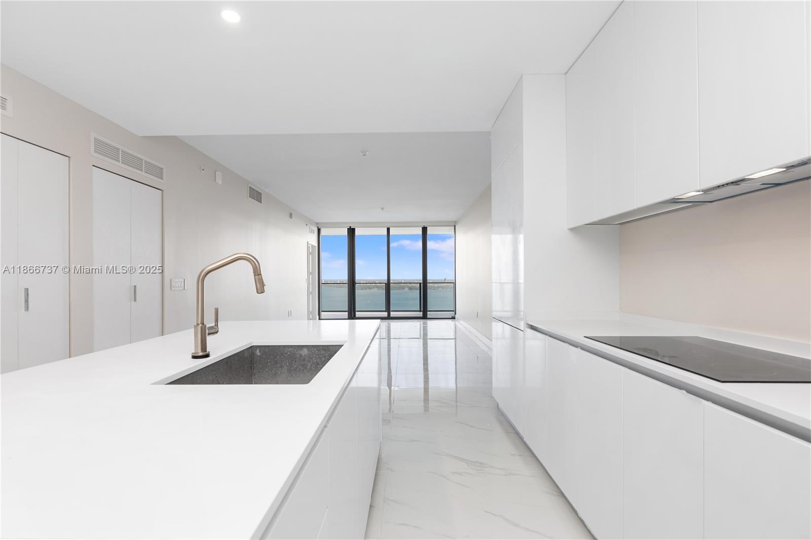 700 Northeast 24th Street, Unit 4206 Miami, FL 33137 - Photo 12 of 79 a kitchen with a sink and cabinets