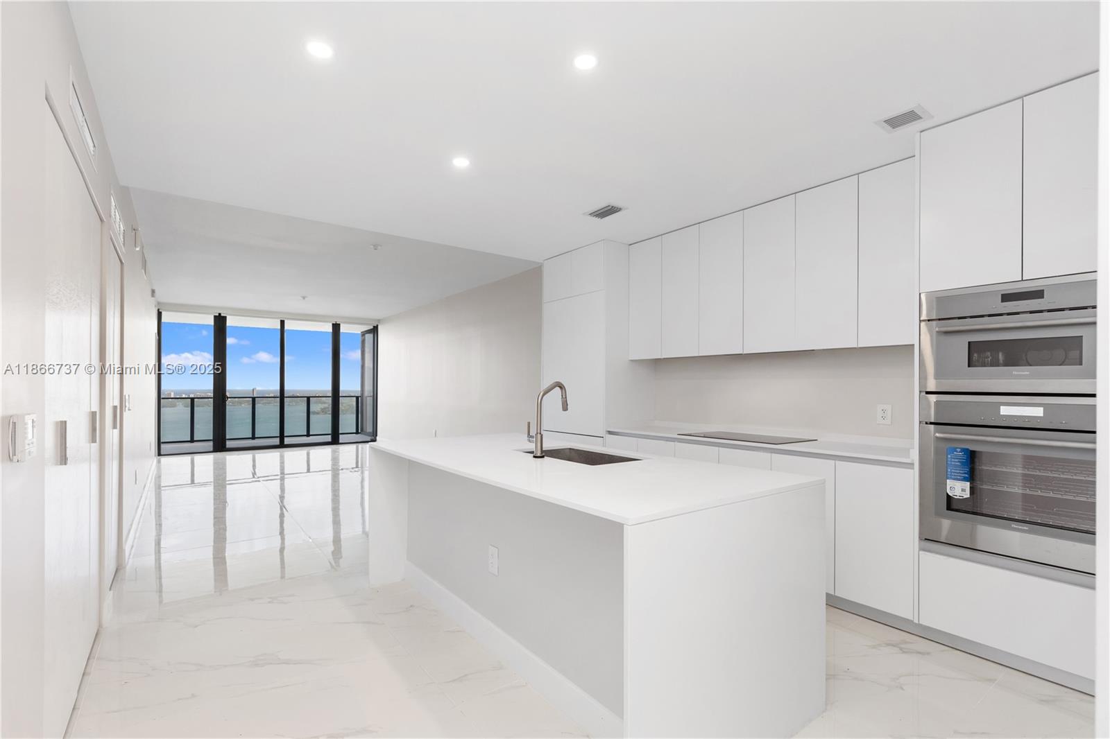 700 Northeast 24th Street, Unit 4206 Miami, FL 33137 - Photo 13 of 79 a kitchen with a sink and cabinets