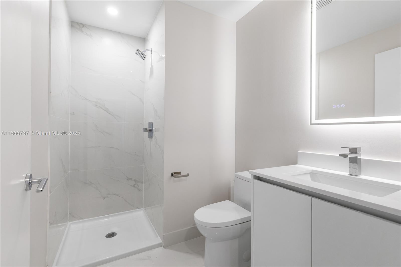 700 Northeast 24th Street, Unit 4206 Miami, FL 33137 - Photo 15 of 79 a bathroom with a sink a toilet and shower