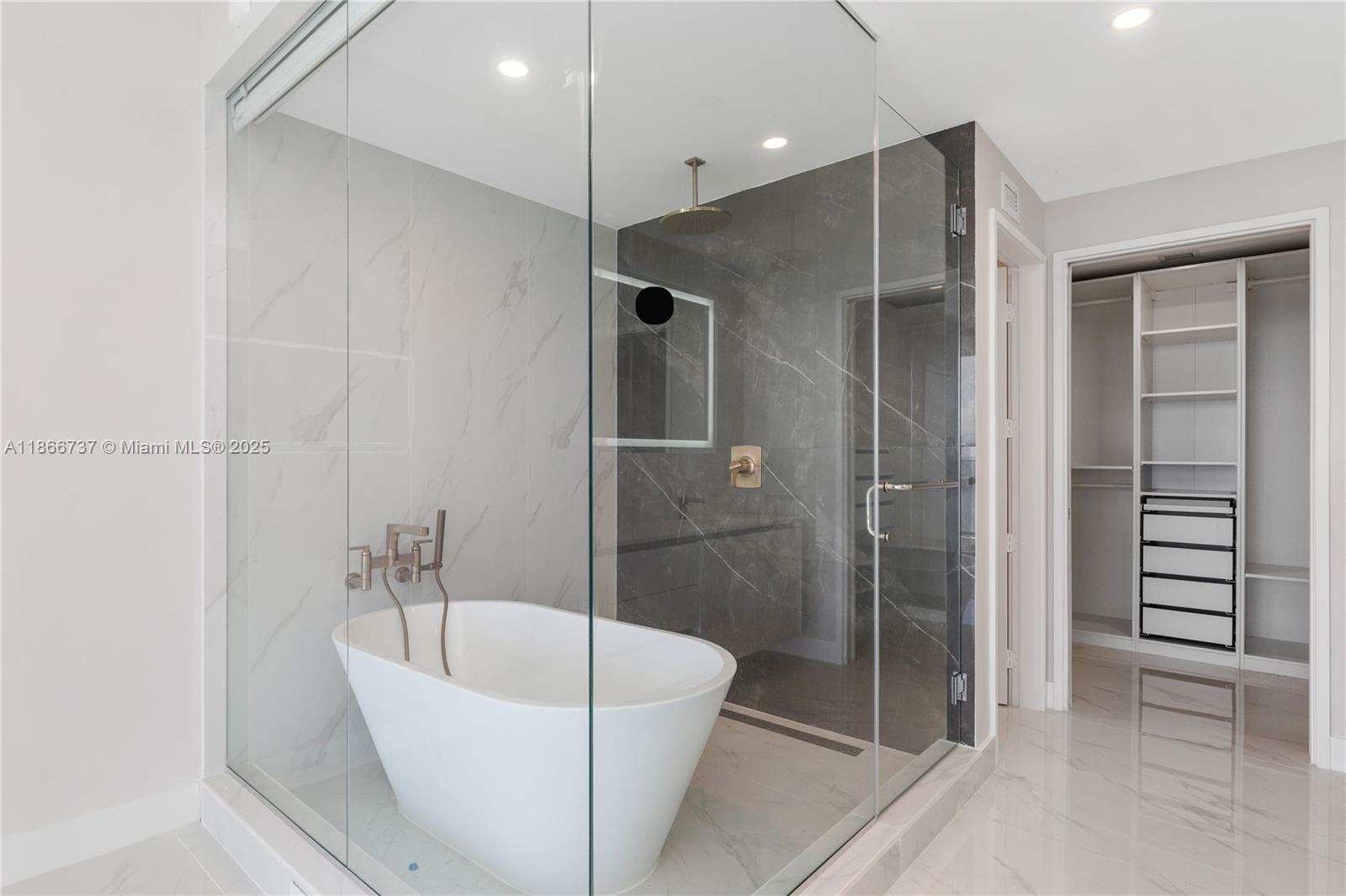 700 Northeast 24th Street, Unit 4206 Miami, FL 33137 - Photo 21 of 79 a bathroom with a bathtub and a shower