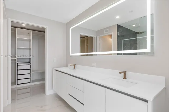 a white bath tub sitting next to a white sink