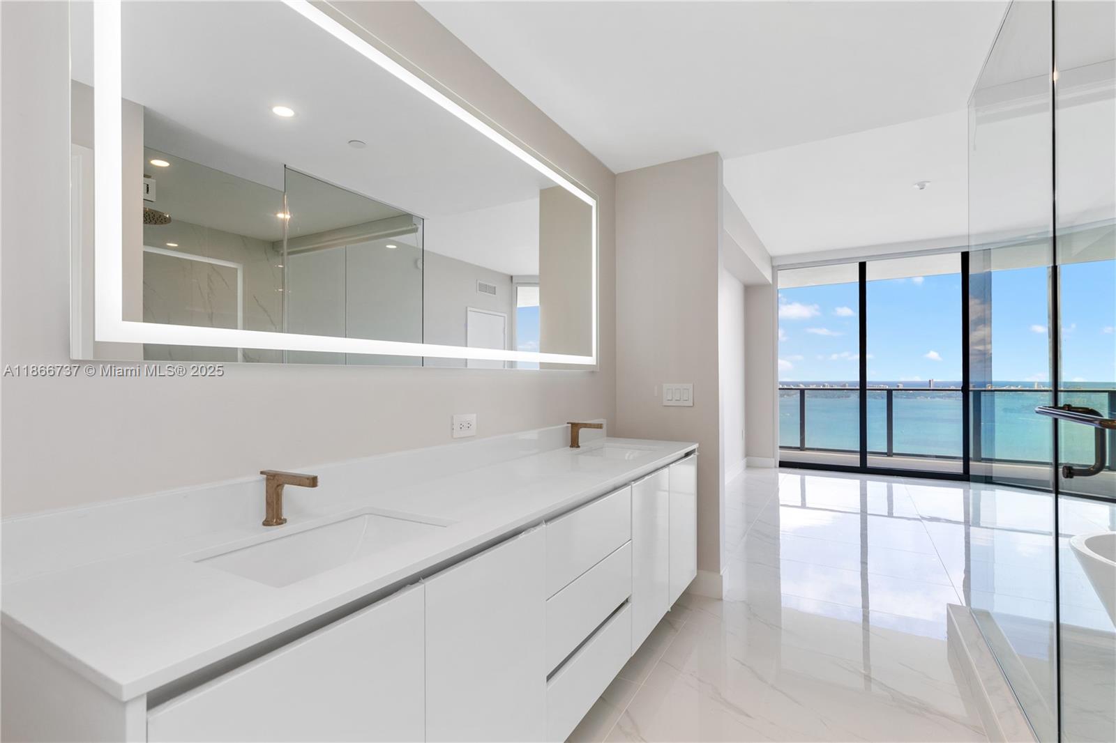 700 Northeast 24th Street, Unit 4206 Miami, FL 33137 - Photo 25 of 79 a bathroom with a sink and a large mirror