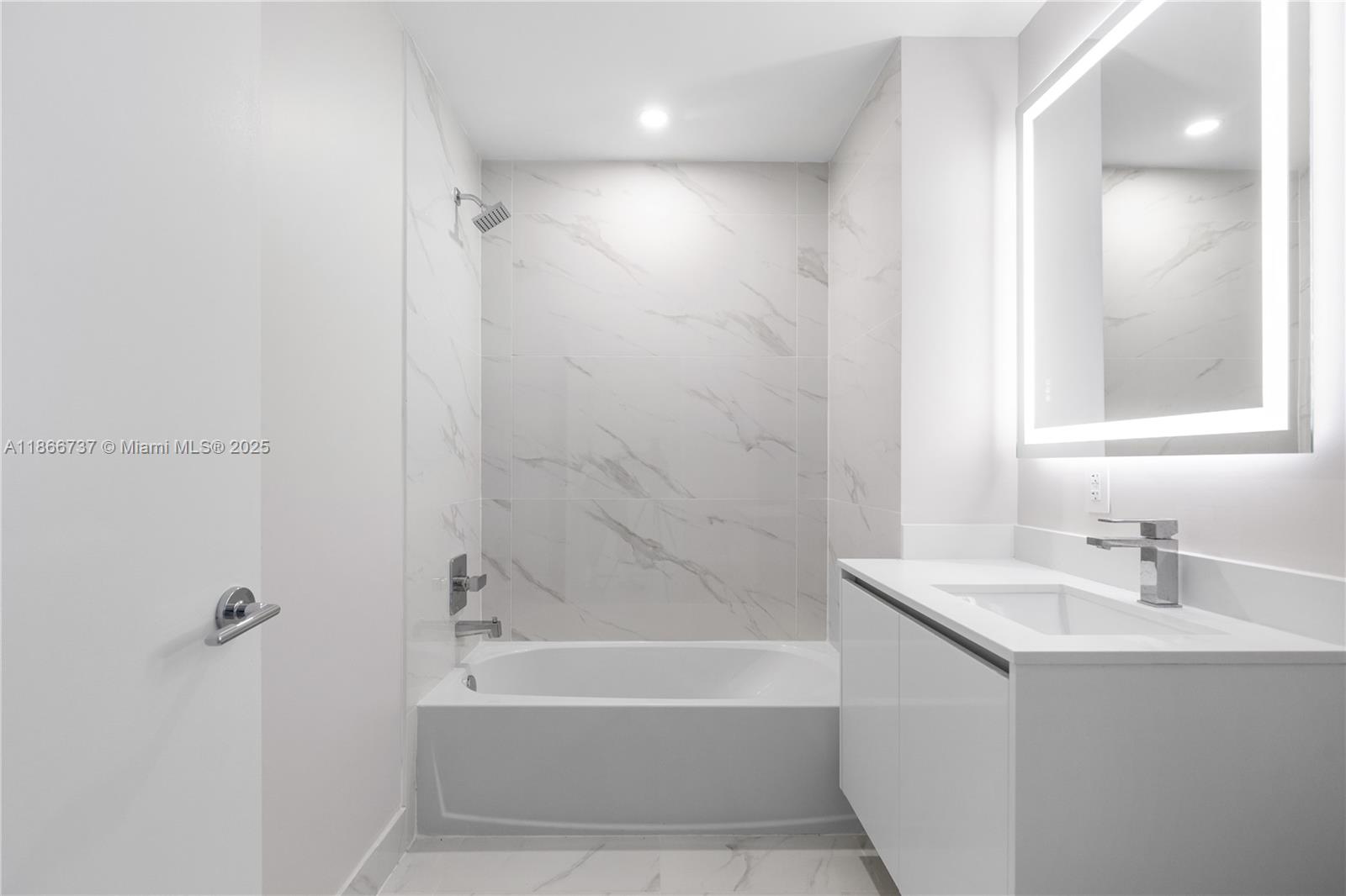 700 Northeast 24th Street, Unit 4206 Miami, FL 33137 - Photo 32 of 79 a white bath tub sitting next to a white sink