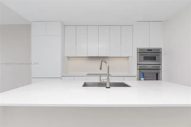a kitchen with a sink and cabinets