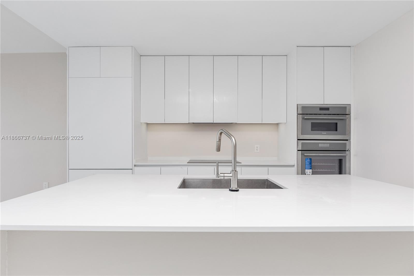 700 Northeast 24th Street, Unit 4206 Miami, FL 33137 - Photo 9 of 79 a kitchen with a sink and a stove