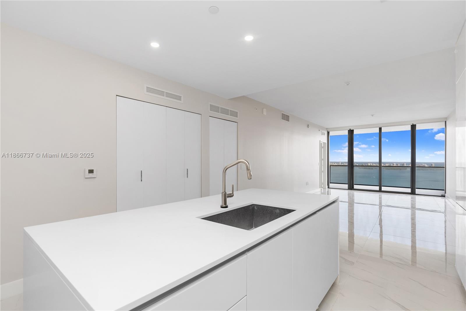 700 Northeast 24th Street, Unit 4206 Miami, FL 33137 - Photo 10 of 79 a kitchen with a sink and white cabinets