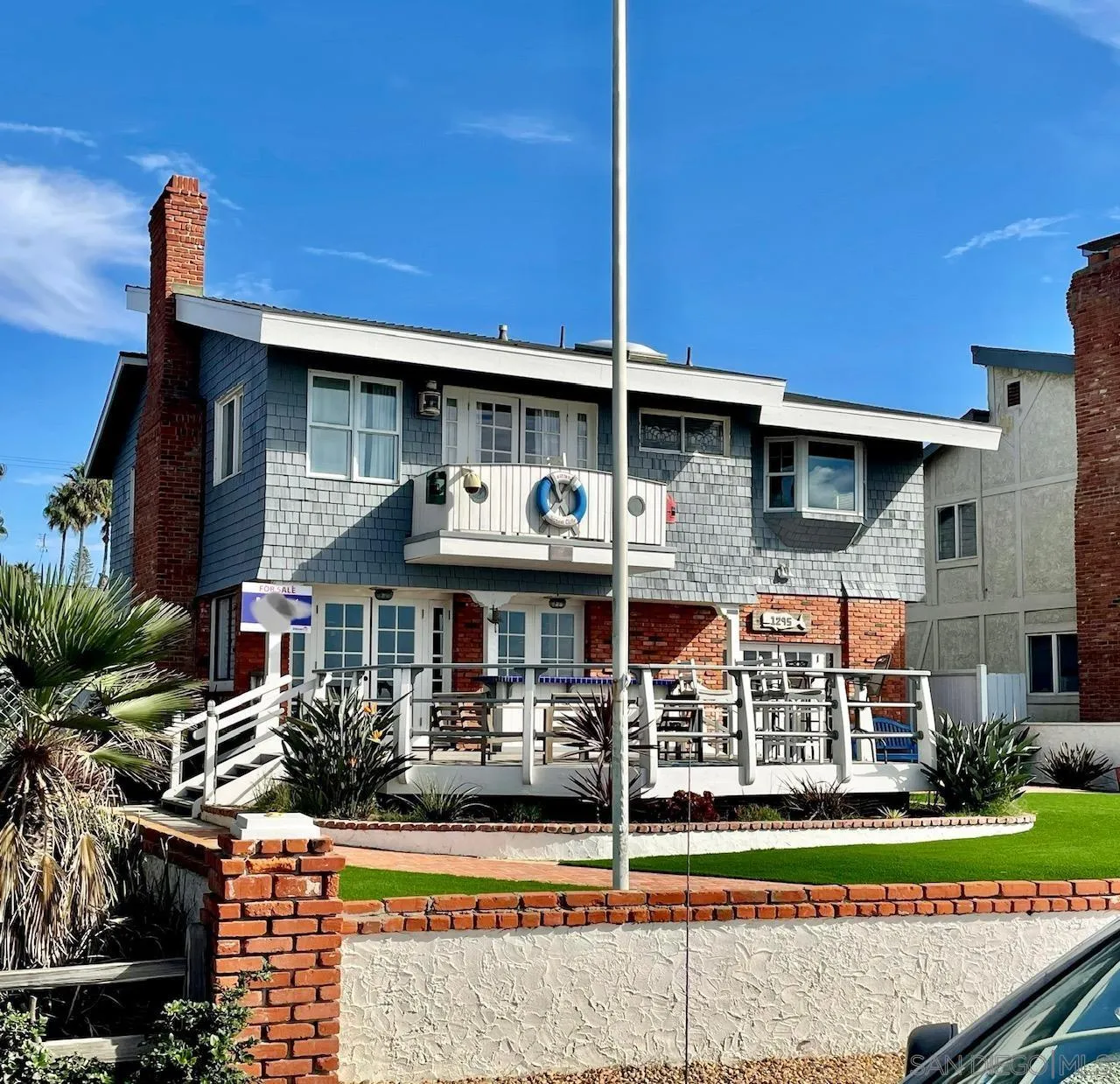 a front view of a house with porch and garden