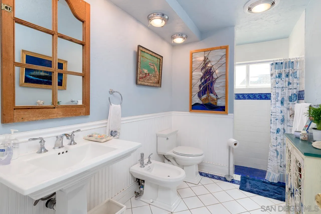 1295 Sunset Cliffs Boulevard San Diego, CA 92107 - Photo 11 of 32 a bathroom with a sink mirror and toilet