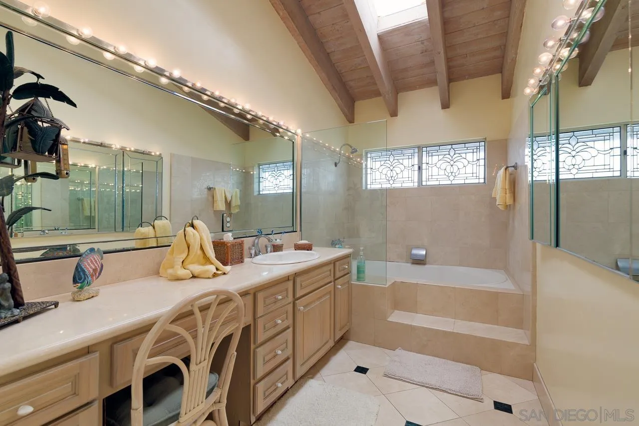 1295 Sunset Cliffs Boulevard San Diego, CA 92107 - Photo 17 of 32 a bathroom with a tub a sink and mirror