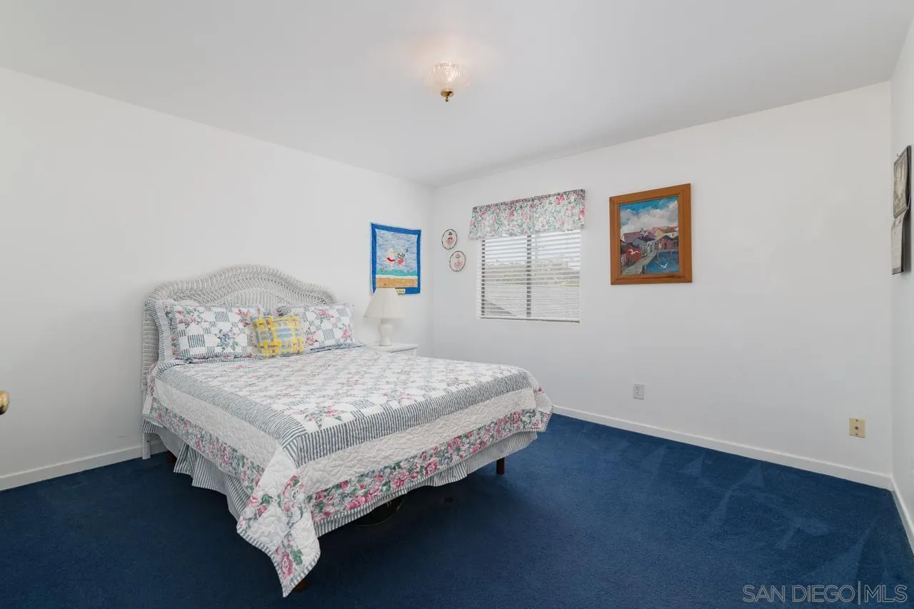 1295 Sunset Cliffs Boulevard San Diego, CA 92107 - Photo 21 of 32 a bedroom with a bed table and window