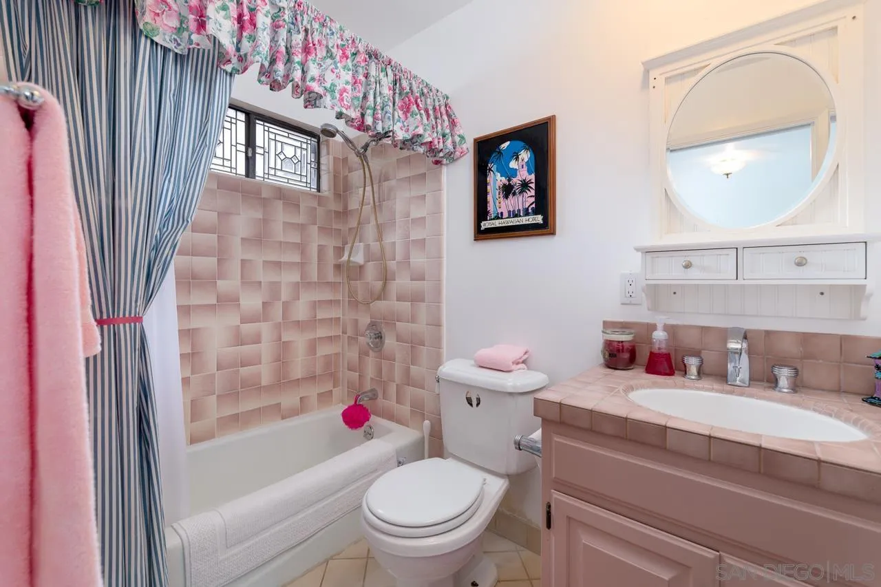 1295 Sunset Cliffs Boulevard San Diego, CA 92107 - Photo 22 of 32 a bathroom with a toilet sink vanity tub and mirror