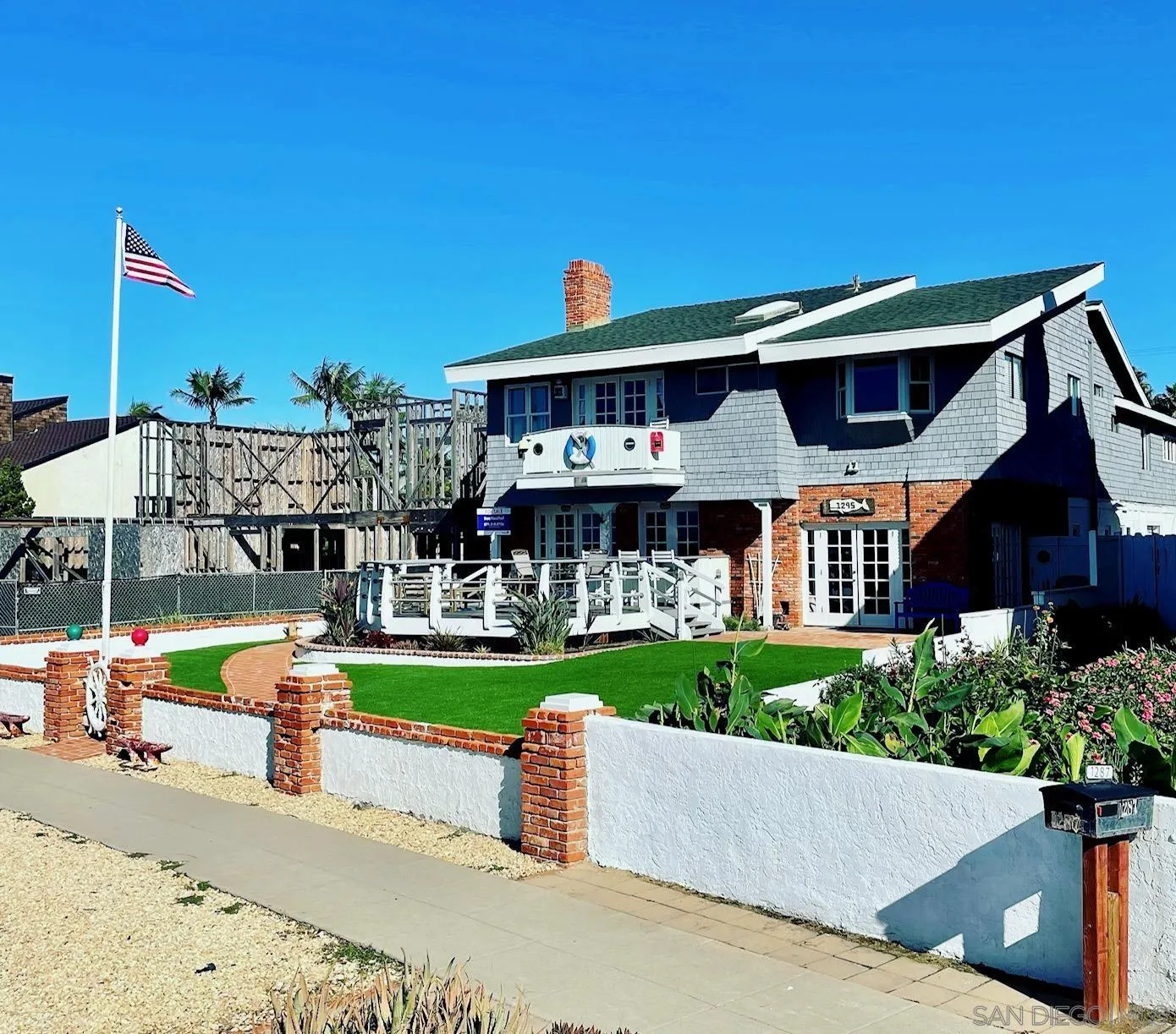 1295 Sunset Cliffs Boulevard San Diego, CA 92107 - Photo 3 of 32 a front view of a house with a yard