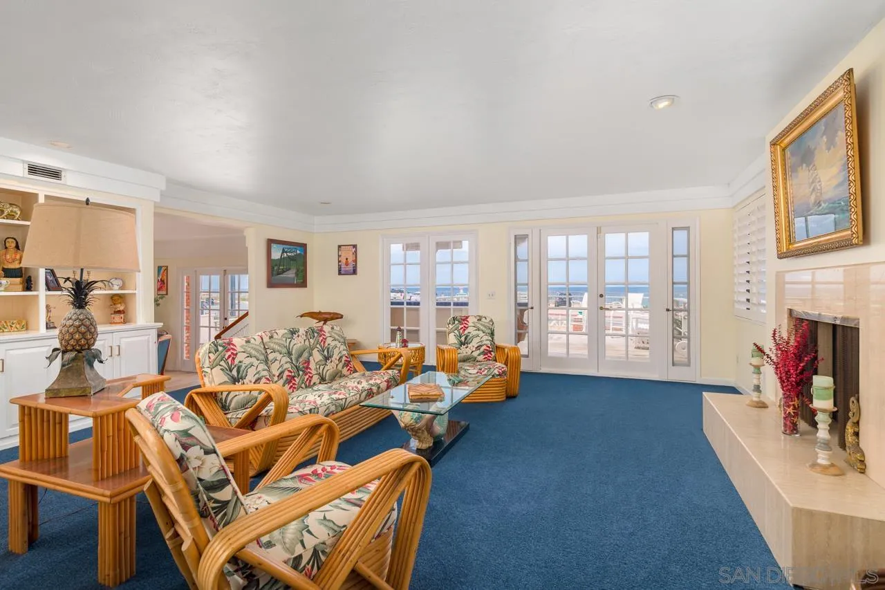 1295 Sunset Cliffs Boulevard San Diego, CA 92107 - Photo 7 of 32 a living room with furniture a fireplace and a flat screen tv