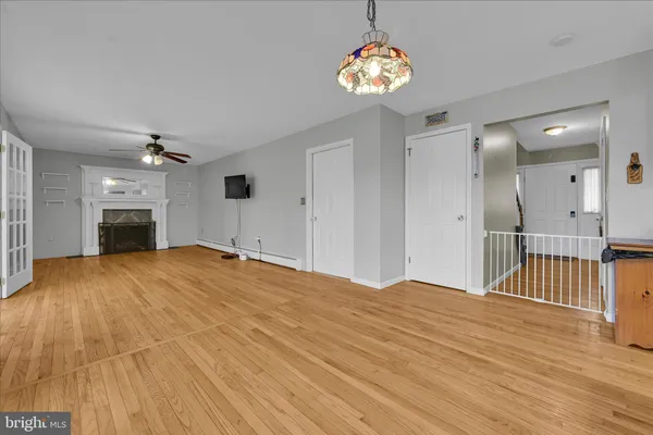 a view of empty room with a fireplace and chandelier
