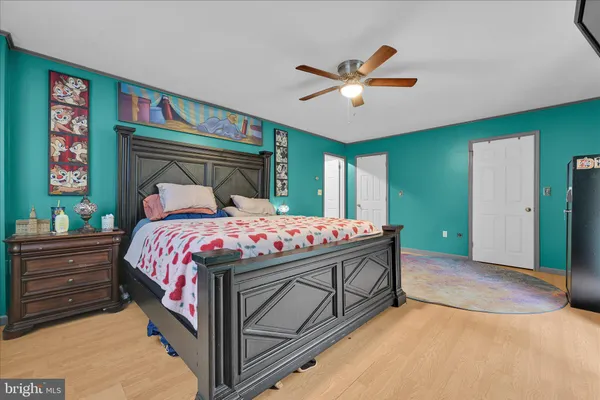 a bedroom with a large bed and a chandelier
