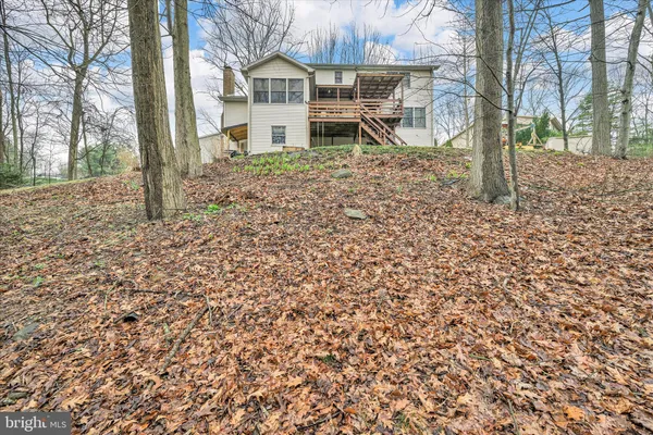 a house that has a tree in front of it