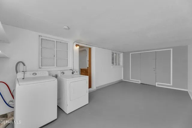 a view of a storage & utility room with dryer and washer