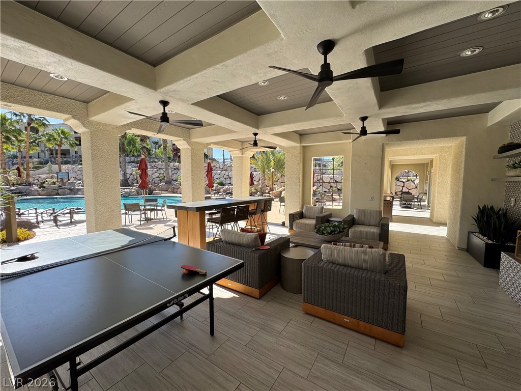 2555 Hampton Road, Unit 4205 Henderson, NV 89052 - Photo 48 of 52 This inviting outdoor lounge space seamlessly connects with a vibrant community pool area.