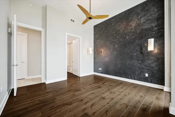 a view of an empty room with wooden floor