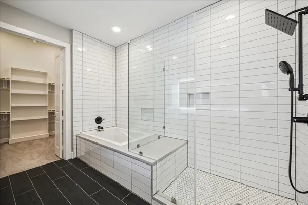 a bathroom with a bathtub and a shower