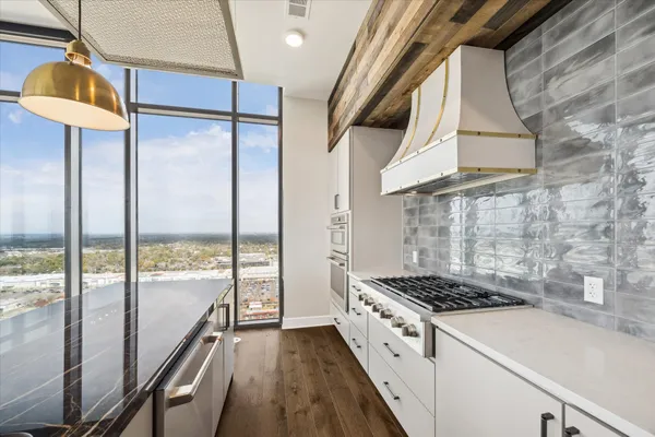 a kitchen with a stove a sink and a refrigerator