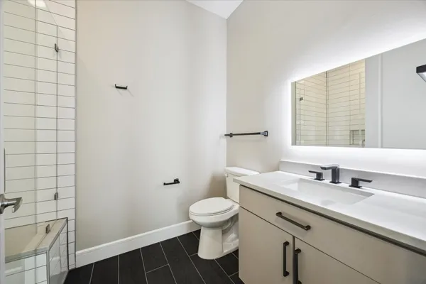 a bathroom with a double vanity sink toilet and a mirror