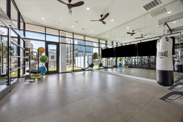 a view of a gym room with gym equipment