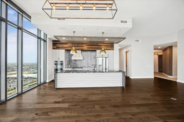 a view of water heater room with wooden floor