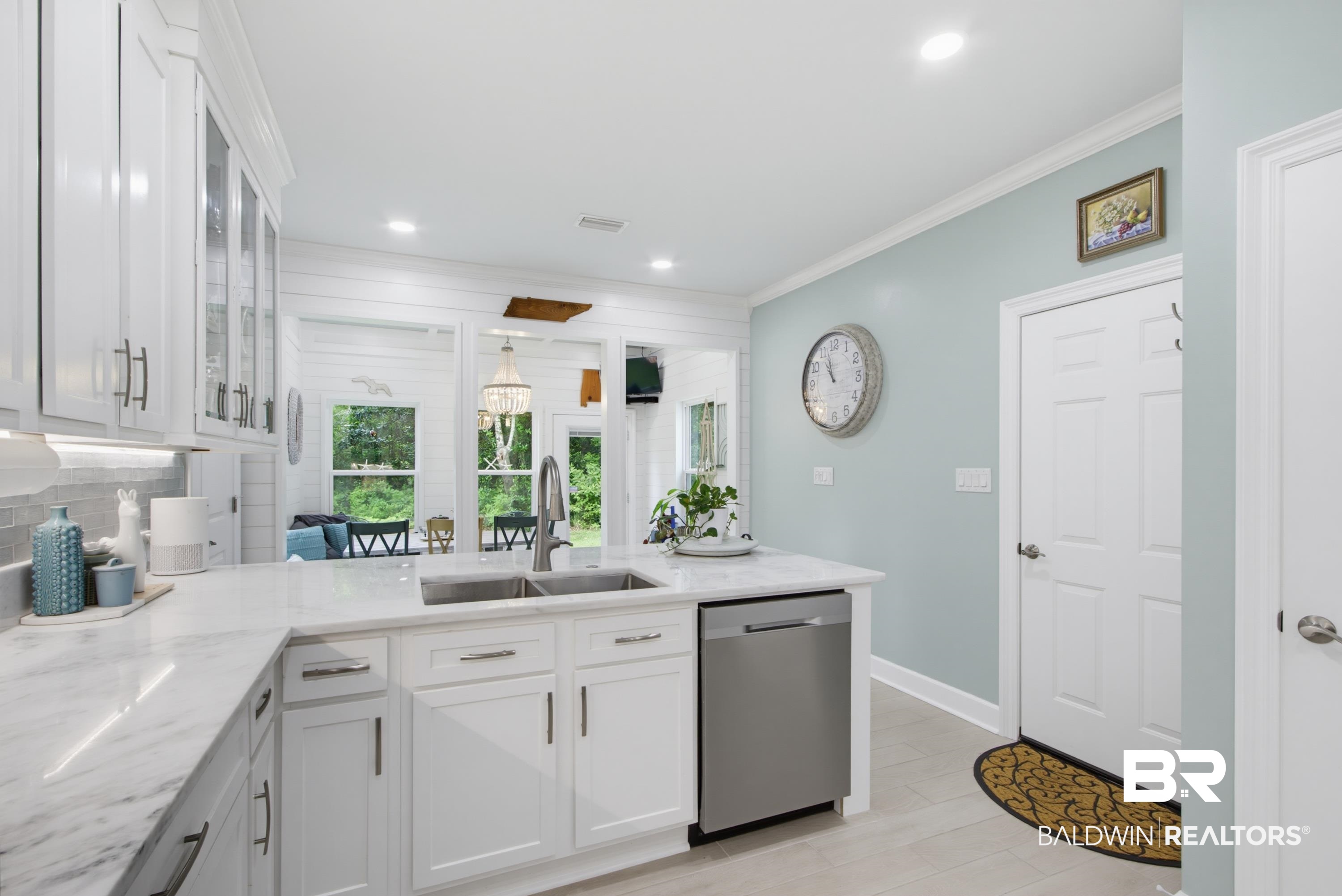 7472 Coopers Landing Road Foley, AL 36535 - Photo 8 of 40 Kitchen featuring white shaker cabinetry, stainless steel sink with gooseneck faucet, light-toned countertops, and light tile wood-finish flooring
