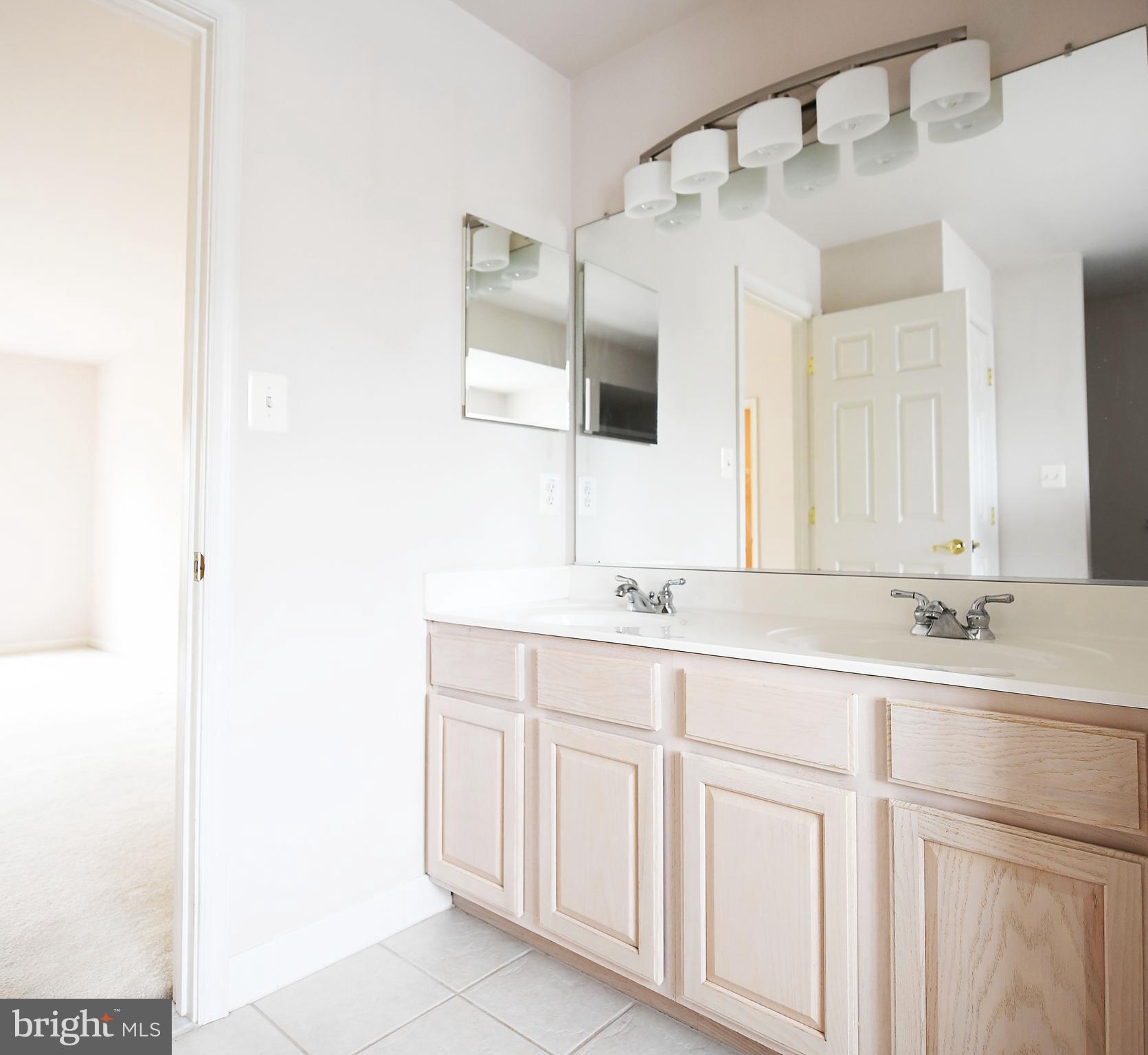 1401 Woodridge Manor Road Fallston, MD 21047 - Photo 20 of 29 Primary bath with double sink and ceramic tile